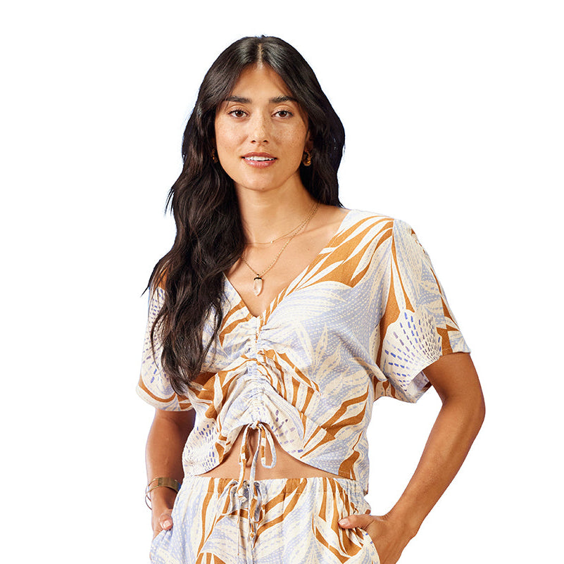 Woman wearing a patterned top on a white background